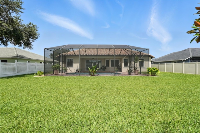 42 Felwood Ln, Palm Coast, FL 32137 - rear view of property with glass enclosure and a fenced backyard