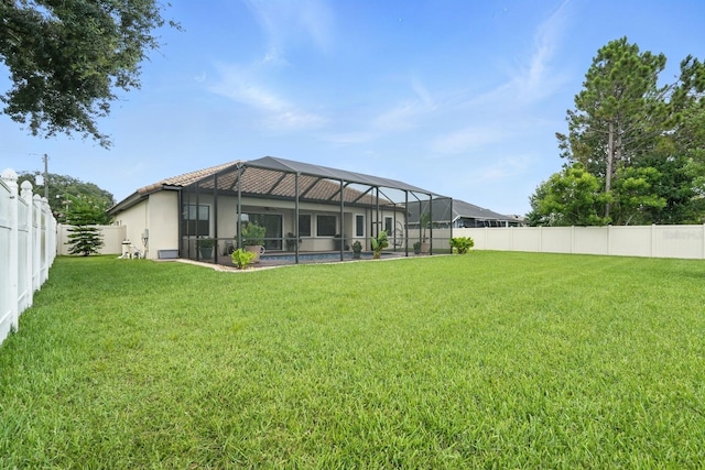 42 Felwood Ln, Palm Coast, FL 32137 - back of house with a fenced backyard and glass enclosure