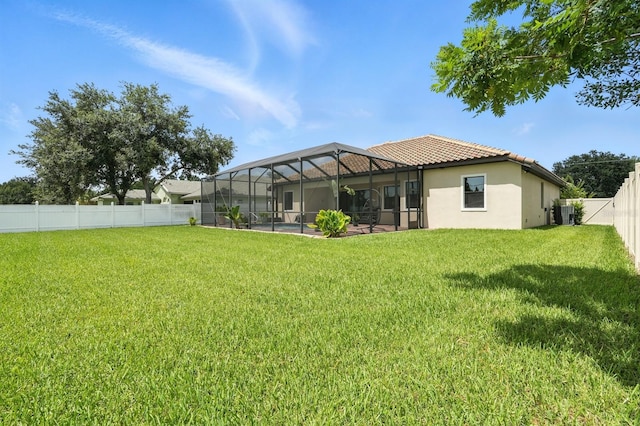 42 Felwood Ln, Palm Coast, FL 32137 - back of property with stucco siding, a fenced backyard, a lanai, and a tiled roof