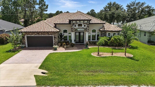 42 Felwood Ln, Palm Coast, FL 32137 - mediterranean / spanish-style home featuring driveway, french doors, an attached garage, and stucco siding