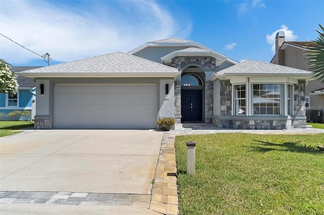 12 Comet Ct, Palm Coast, FL 32137 - single story home with stone siding, concrete driveway, an attached garage, a front lawn, and stucco siding