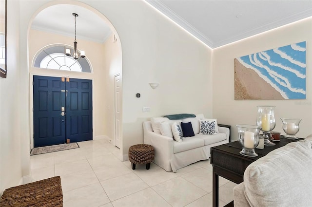 12 Comet Ct, Palm Coast, FL 32137 - foyer with arched walkways, crown molding, light tile patterned floors, a chandelier, and a towering ceiling