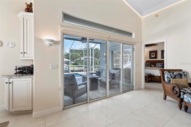 12 Comet Ct, Palm Coast, FL 32137 - doorway to outside with a sunroom, ornamental molding, and light tile patterned flooring