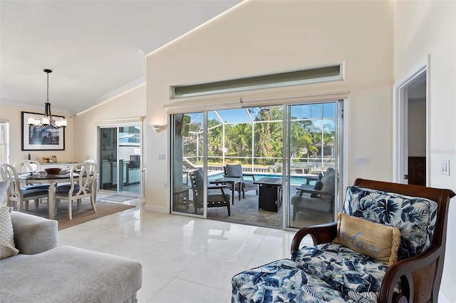 12 Comet Ct, Palm Coast, FL 32137 - living area featuring a chandelier, ornamental molding, light tile patterned floors, high vaulted ceiling, and a sunroom