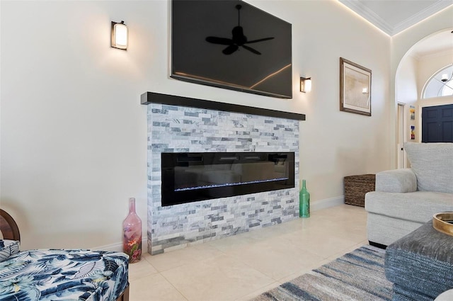 12 Comet Ct, Palm Coast, FL 32137 - living area featuring ornamental molding, a ceiling fan, arched walkways, a stone fireplace, and tile patterned flooring