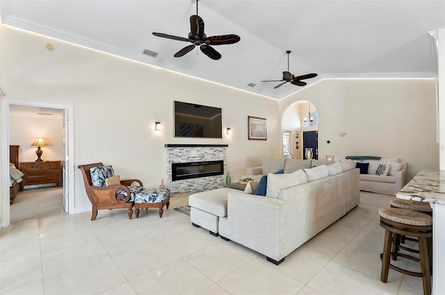 12 Comet Ct, Palm Coast, FL 32137 - living area with lofted ceiling, ceiling fan, light tile patterned floors, a glass covered fireplace, and arched walkways