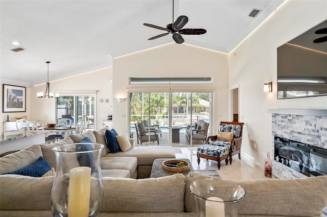 12 Comet Ct, Palm Coast, FL 32137 - tiled living room featuring crown molding, ceiling fan, lofted ceiling, a stone fireplace, and a chandelier
