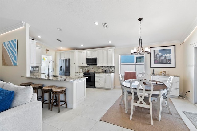12 Comet Ct, Palm Coast, FL 32137 - kitchen featuring black microwave, stainless steel fridge with ice dispenser, crown molding, electric range oven, and a peninsula