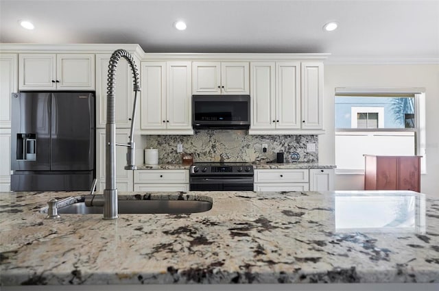 12 Comet Ct, Palm Coast, FL 32137 - kitchen with black electric range oven, fridge with ice dispenser, light stone countertops, decorative backsplash, and recessed lighting