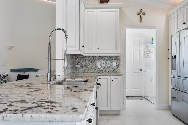 12 Comet Ct, Palm Coast, FL 32137 - kitchen featuring stainless steel fridge with ice dispenser, ornamental molding, light stone counters, white cabinets, and light tile patterned floors