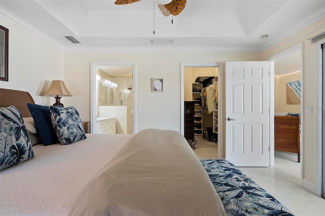 12 Comet Ct, Palm Coast, FL 32137 - bedroom featuring a tray ceiling, a spacious closet, ornamental molding, ensuite bath, and a closet