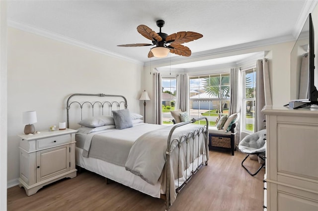 12 Comet Ct, Palm Coast, FL 32137 - bedroom with light wood-style floors, crown molding, and a ceiling fan