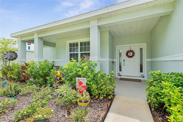 7 Pine Bush Ln, Palm Coast, FL 32164 - property entrance featuring stucco siding and a porch