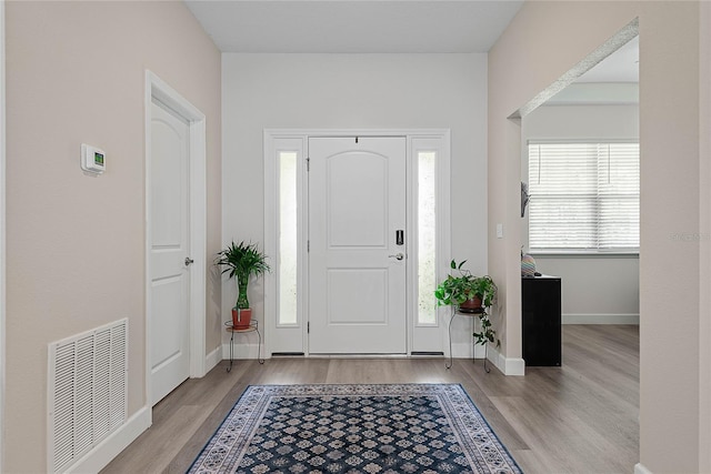 7 Pine Bush Ln, Palm Coast, FL 32164 - entrance foyer featuring wood finished floors and baseboards