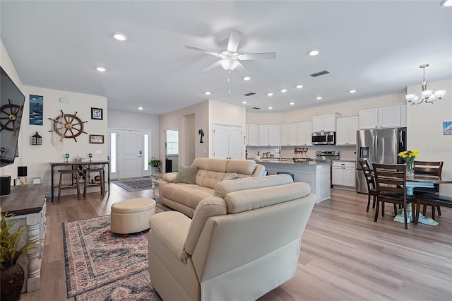 7 Pine Bush Ln, Palm Coast, FL 32164 - living area with a ceiling fan, a chandelier, light wood-style flooring, and recessed lighting