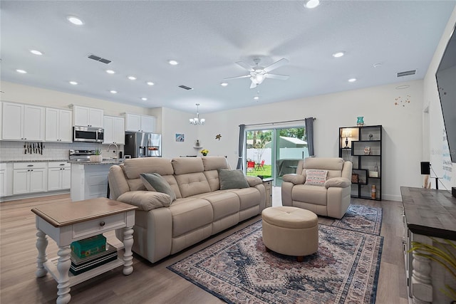 7 Pine Bush Ln, Palm Coast, FL 32164 - living area with ceiling fan, light wood-style floors, recessed lighting, and a chandelier