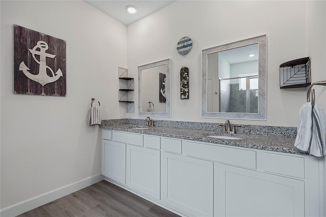 7 Pine Bush Ln, Palm Coast, FL 32164 - bathroom with double vanity, wood finished floors, and a shower with shower door