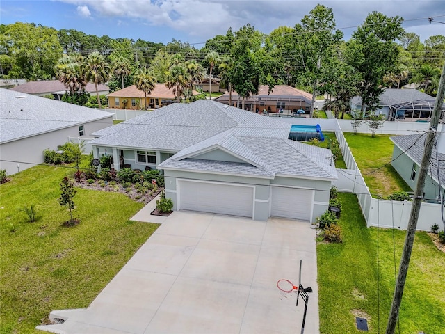 7 Pine Bush Ln, Palm Coast, FL 32164 - view of front of house featuring roof with shingles, an attached garage, driveway, a fenced backyard, and a residential view