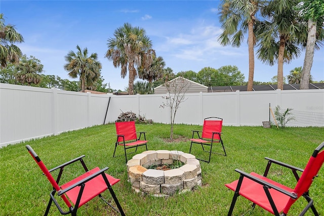 7 Pine Bush Ln, Palm Coast, FL 32164 - fenced backyard with an outdoor fire pit