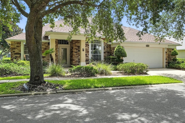 67 Lagare St, Palm Coast, FL 32137 - view of front facade with stone siding, an attached garage, concrete driveway, and roof with shingles
