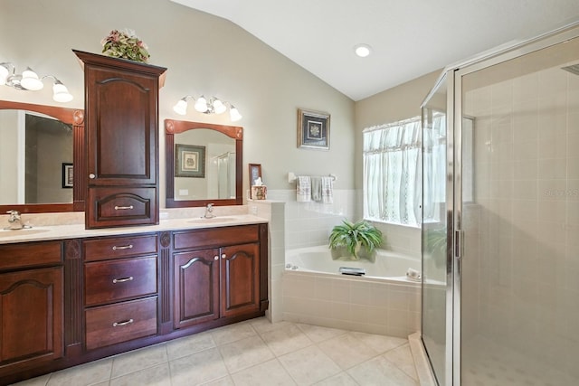 67 Lagare St, Palm Coast, FL 32137 - full bath featuring vaulted ceiling, a stall shower, tile patterned flooring, a bath, and double vanity