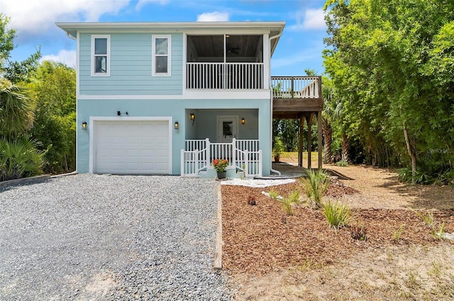 19 Bay Dr, Palm Coast, FL 32137 - beach home featuring an attached garage, driveway, stucco siding, a sunroom, and a deck