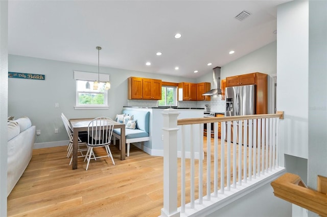 19 Bay Dr, Palm Coast, FL 32137 - kitchen featuring wall chimney exhaust hood, appliances with stainless steel finishes, light wood finished floors, a peninsula, and recessed lighting