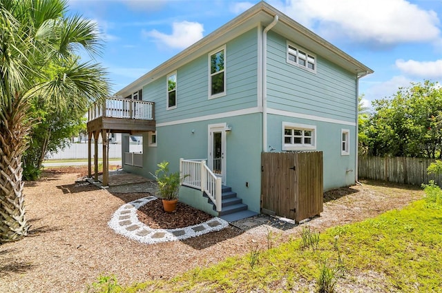 19 Bay Dr, Palm Coast, FL 32137 - back of property with stucco siding and a deck