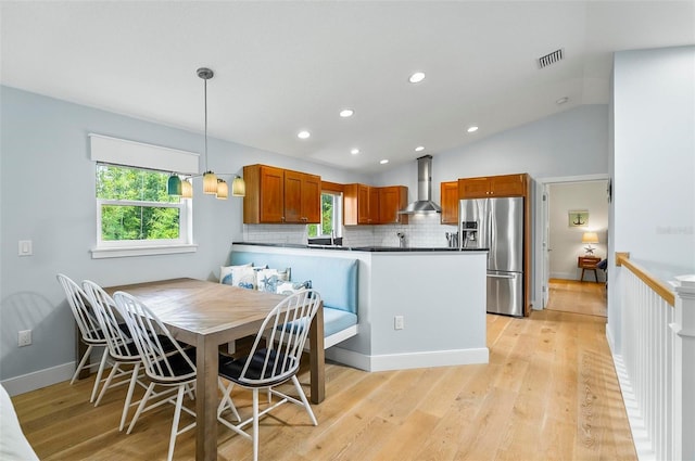 19 Bay Dr, Palm Coast, FL 32137 - dining area with healthy amount of natural light, light wood-type flooring, vaulted ceiling, and recessed lighting
