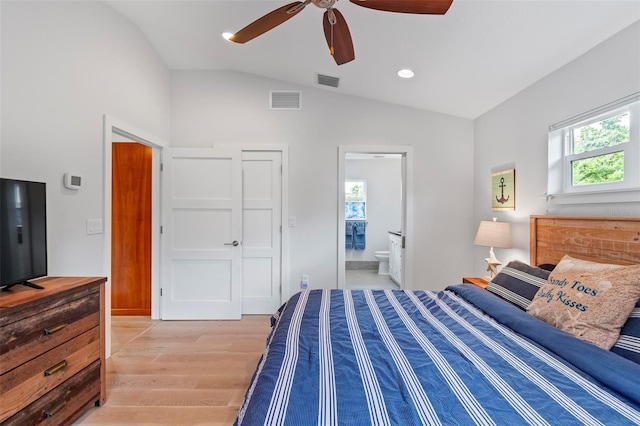 19 Bay Dr, Palm Coast, FL 32137 - bedroom with multiple windows, light wood-style flooring, vaulted ceiling, ensuite bath, and ceiling fan
