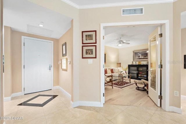 231 Riverside Dr Unit 103-1, Daytona Beach, FL 32117 - foyer with light tile patterned flooring, ornamental molding, a ceiling fan, and a glass covered fireplace