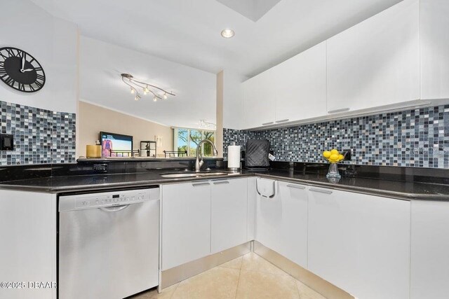 231 Riverside Dr Unit 103-1, Daytona Beach, FL 32117 - kitchen featuring dishwasher, white cabinetry, tasteful backsplash, light tile patterned flooring, and dark stone counters