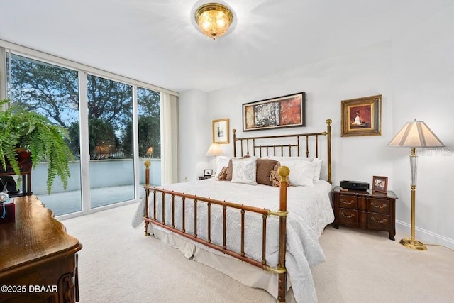 231 Riverside Dr Unit 103-1, Daytona Beach, FL 32117 - bedroom featuring carpet, access to exterior, and expansive windows
