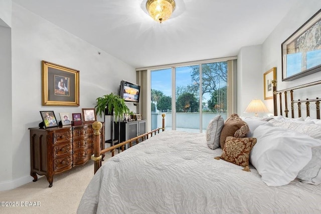 231 Riverside Dr Unit 103-1, Daytona Beach, FL 32117 - carpeted bedroom with access to outside and expansive windows