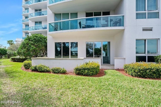 231 Riverside Dr Unit 103-1, Daytona Beach, FL 32117 - back of house featuring stucco siding and a yard
