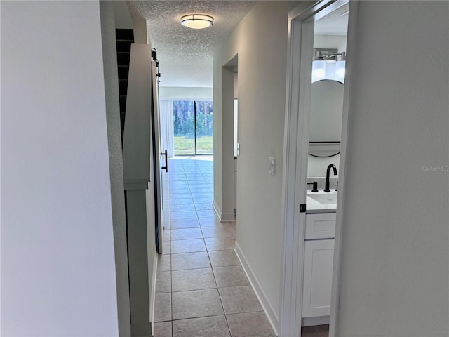 3628 S Central Ave Unit 5, Flagler Beach, FL 32136 - hall featuring light tile patterned floors and a textured ceiling