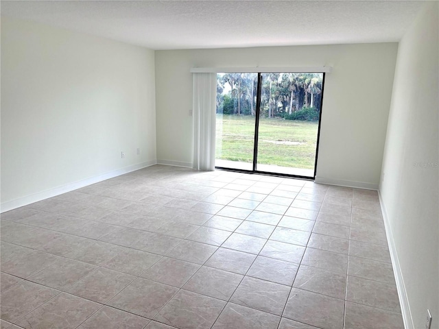 3628 S Central Ave Unit 5, Flagler Beach, FL 32136 - spare room featuring light tile patterned floors and baseboards