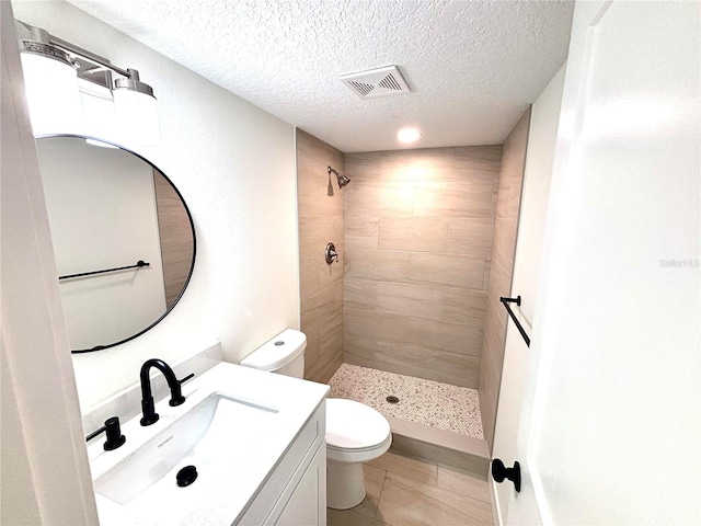 3628 S Central Ave Unit 5, Flagler Beach, FL 32136 - full bath with a tile shower, vanity, a textured ceiling, and tile patterned floors
