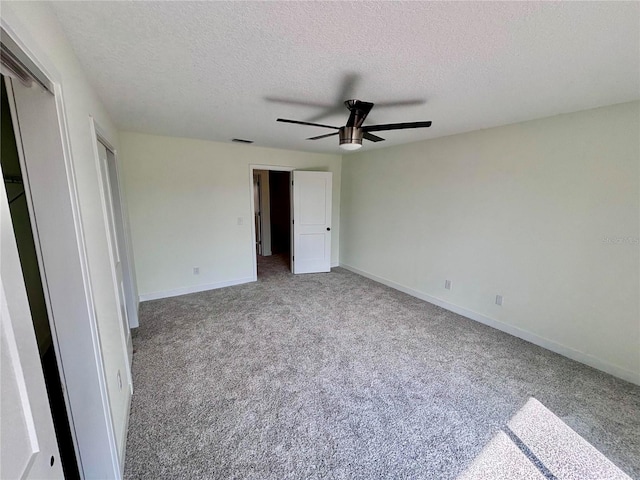 3628 S Central Ave Unit 5, Flagler Beach, FL 32136 - unfurnished bedroom featuring a textured ceiling, carpet, two closets, and ceiling fan