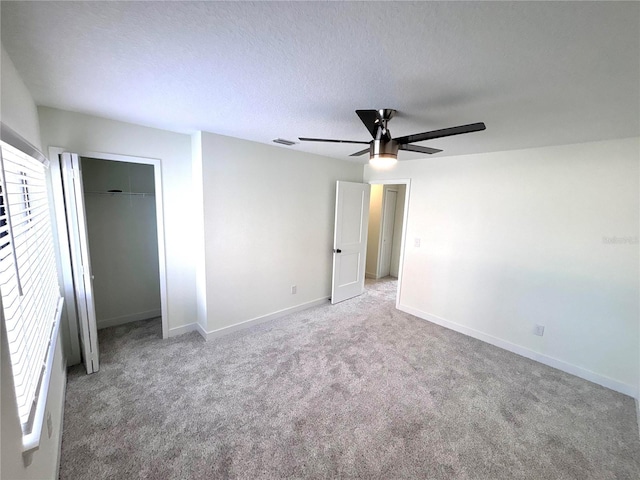 3628 S Central Ave Unit 5, Flagler Beach, FL 32136 - unfurnished bedroom featuring carpet, a ceiling fan, a closet, and a textured ceiling