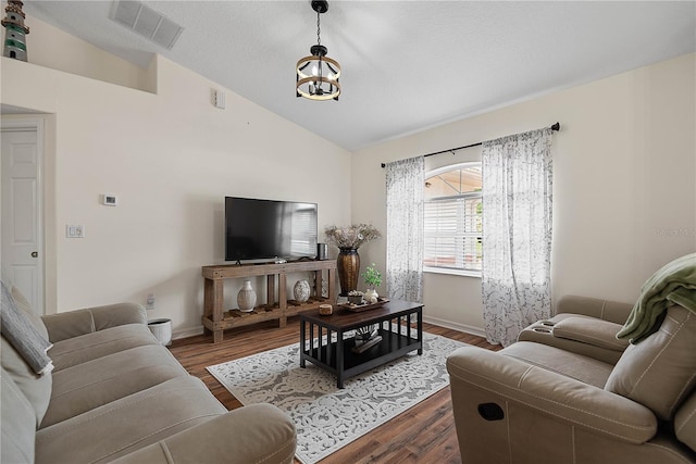 54 Pine Grove Dr, Palm Coast, FL 32164 - living room with lofted ceiling, wood finished floors, and a chandelier