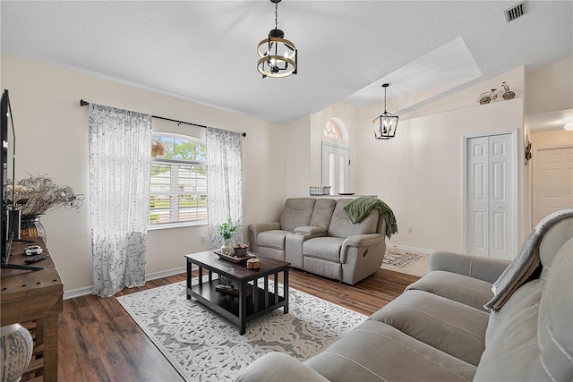54 Pine Grove Dr, Palm Coast, FL 32164 - living room featuring a chandelier, lofted ceiling, and wood finished floors