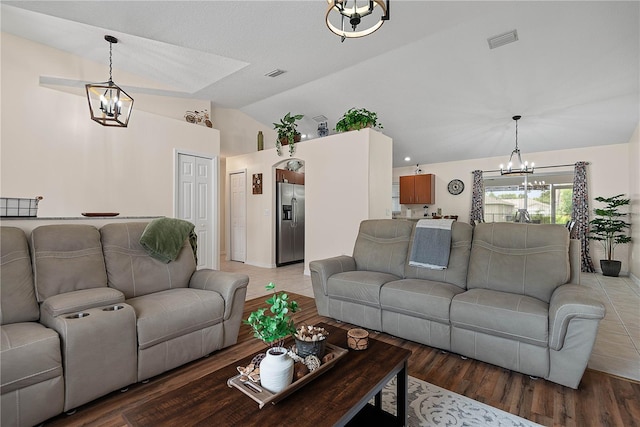 54 Pine Grove Dr, Palm Coast, FL 32164 - living room with a chandelier, light wood-style flooring, and high vaulted ceiling