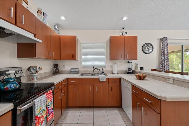 54 Pine Grove Dr, Palm Coast, FL 32164 - kitchen featuring stainless steel range with electric stovetop, under cabinet range hood, white dishwasher, a peninsula, and light countertops