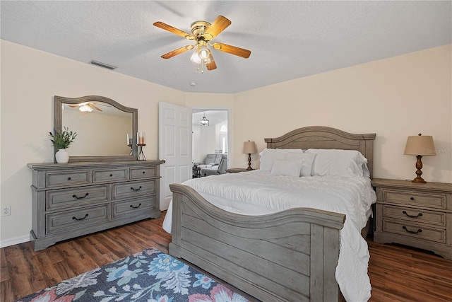 54 Pine Grove Dr, Palm Coast, FL 32164 - bedroom with dark wood finished floors, a ceiling fan, and a textured ceiling