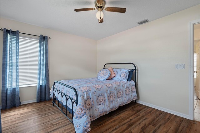 54 Pine Grove Dr, Palm Coast, FL 32164 - bedroom with multiple windows, wood finished floors, and ceiling fan
