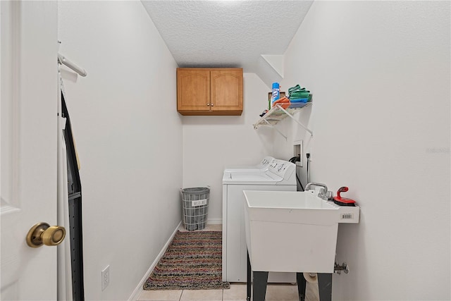 54 Pine Grove Dr, Palm Coast, FL 32164 - laundry room featuring washing machine and clothes dryer, a textured ceiling, light tile patterned flooring, and cabinet space