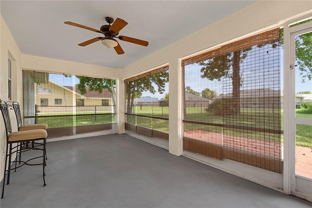 54 Pine Grove Dr, Palm Coast, FL 32164 - unfurnished sunroom featuring a ceiling fan and plenty of natural light