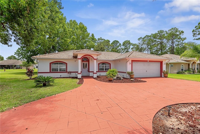 54 Pine Grove Dr, Palm Coast, FL 32164 - mediterranean / spanish-style home with a tiled roof, stucco siding, a front lawn, and a garage