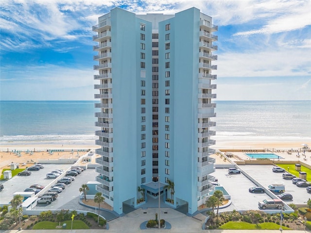 3047 S Atlantic Ave Unit 706, Daytona Beach, FL 32118 - view of apartment building / complex featuring view of water and beach and uncovered parking
